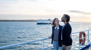 Couple on a ferry looking out to sea